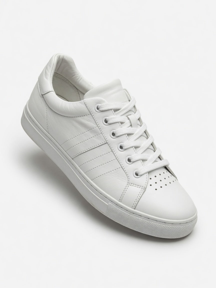 White leather sneaker on a plain studio background.